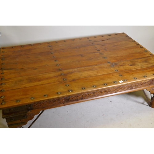 1198 - A large Indian coffee table, with iron mounts and brackets and carved frieze, 45