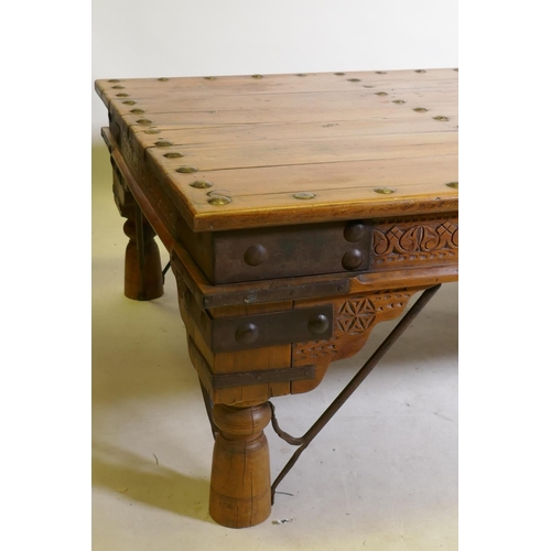 1198 - A large Indian coffee table, with iron mounts and brackets and carved frieze, 45