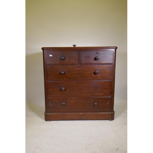 1200 - A Victorian mahogany chest of two over three drawers, with bun handles and lower cushion drawer, rai... 