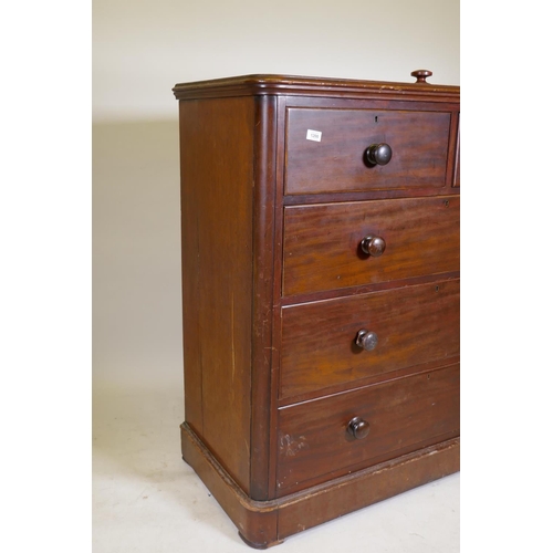 1200 - A Victorian mahogany chest of two over three drawers, with bun handles and lower cushion drawer, rai... 