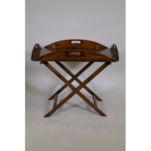 1201 - A stained pine butlers tray and stand, with brass hinged drop sides, 19