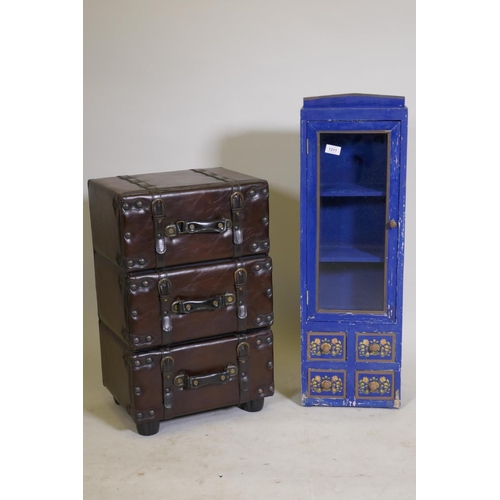 1211 - A chest of three drawers in the form of stacked leather suitcases, and a painted cabinet with glazed... 