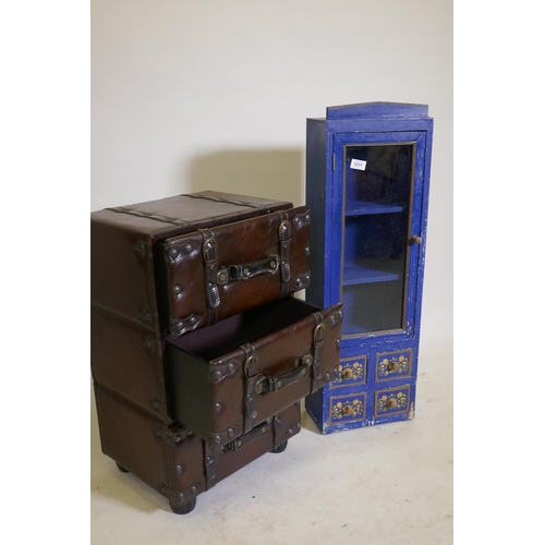 1211 - A chest of three drawers in the form of stacked leather suitcases, and a painted cabinet with glazed... 