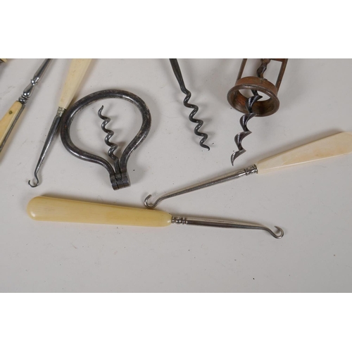 17 - Three vintage corkscrews and five Victorian button hooks