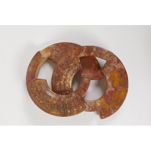 18 - A Chinese archaic carved hardstone puzzle ring, 4½