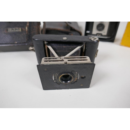 2 - A Kodak Brownie Reflex camera in original box, an Actus Ansco Vest pocket camera and a Kodak Junior ... 