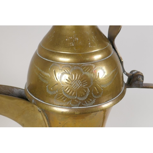 24 - A Turkish brass coffee pot with chased floral decoration, 23½