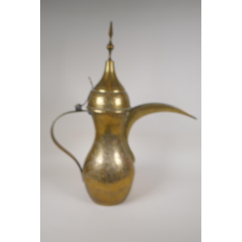 24 - A Turkish brass coffee pot with chased floral decoration, 23½