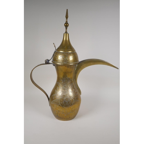 24 - A Turkish brass coffee pot with chased floral decoration, 23½