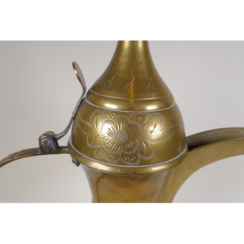 24 - A Turkish brass coffee pot with chased floral decoration, 23½