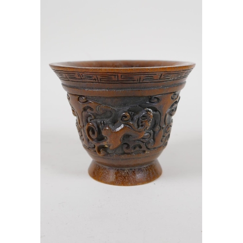 25 - A Chinese faux horn libation cup with raised kylin decoration, impressed mark to base, 4