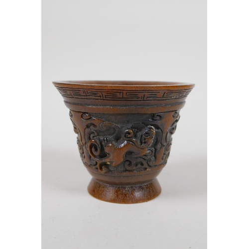 25 - A Chinese faux horn libation cup with raised kylin decoration, impressed mark to base, 4