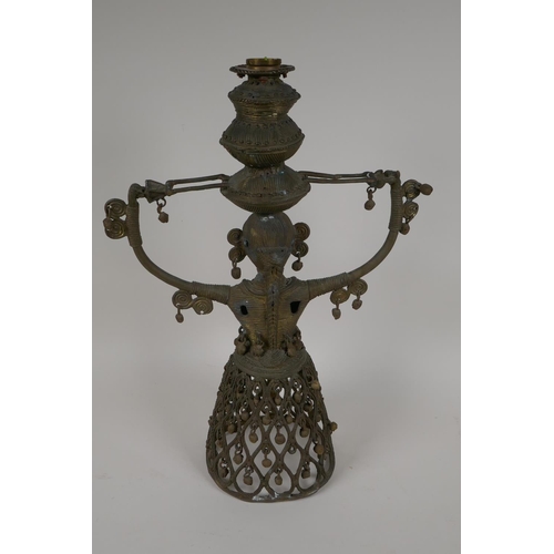 3 - An Indian bronze figural lamp base, cast as a female figure supporting a lamp holder, 16