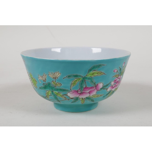 45 - A polychrome porcelain rice bowl with enamelled bird and floral decoration  on a turquoise grou... 