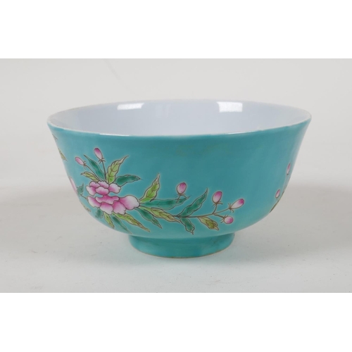 45 - A polychrome porcelain rice bowl with enamelled bird and floral decoration  on a turquoise grou... 