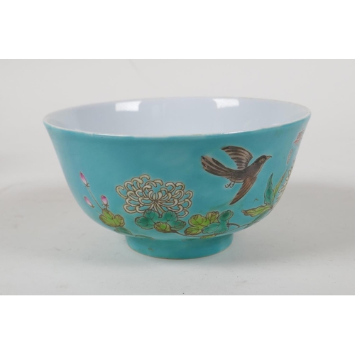 45 - A polychrome porcelain rice bowl with enamelled bird and floral decoration  on a turquoise grou... 