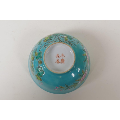 45 - A polychrome porcelain rice bowl with enamelled bird and floral decoration  on a turquoise grou... 