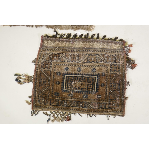 46 - Two Middle Eastern carpet bags / pillows, an embroidered purse and a similar rug with a geometric de... 