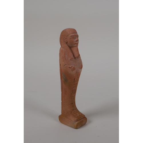 56 - An Egyptian terracotta shabti with impressed hieroglyphs, 4½