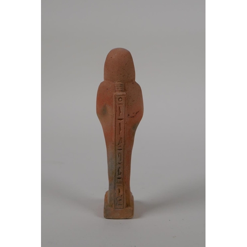 56 - An Egyptian terracotta shabti with impressed hieroglyphs, 4½