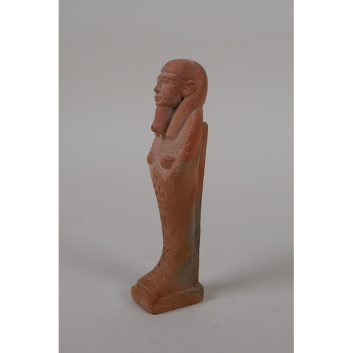 56 - An Egyptian terracotta shabti with impressed hieroglyphs, 4½