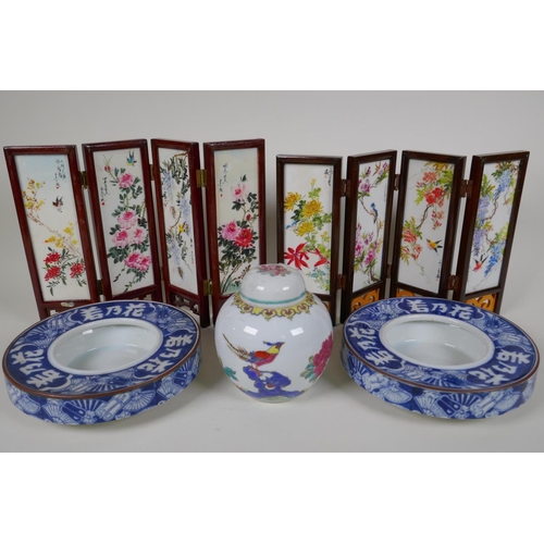 58 - A pair of Japanese blue and white porcelain shallow bowls decorated with fans and characters, 7