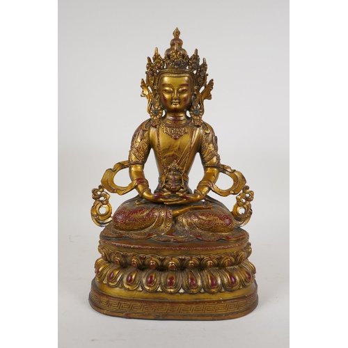 71 - A Sino Tibetan gilt bronze figure of Buddha seated on a lotus throne, 14½