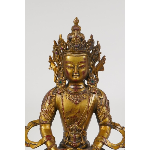 71 - A Sino Tibetan gilt bronze figure of Buddha seated on a lotus throne, 14½