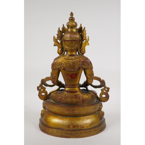 71 - A Sino Tibetan gilt bronze figure of Buddha seated on a lotus throne, 14½