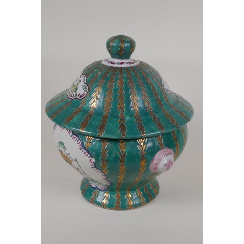 9 - A Continental porcelain jar and cover with panels decorated with coats of arms, on a green and gilt ... 