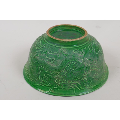 16 - A Chinese green glazed porcelain bowl embossed with dragons, 6 character mark to base, 6