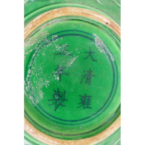 16 - A Chinese green glazed porcelain bowl embossed with dragons, 6 character mark to base, 6