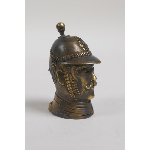 22 - A brass vesta case in the form of a policeman's head bust, 2½