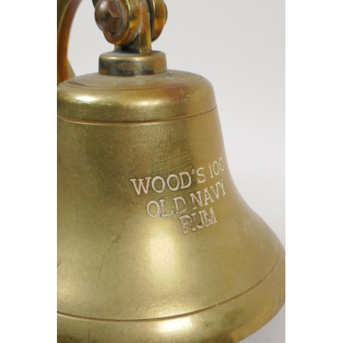 27 - A brass pub bell, engraved 'Wood's 100 Yr old Navy Rum', 7