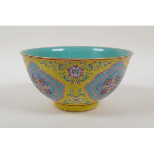 30 - An enamelled porcelain rice bowl with famille rose decoration on a yellow ground and a turquoise int... 