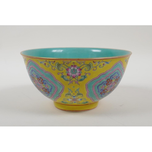 30 - An enamelled porcelain rice bowl with famille rose decoration on a yellow ground and a turquoise int... 