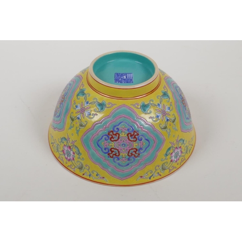 30 - An enamelled porcelain rice bowl with famille rose decoration on a yellow ground and a turquoise int... 