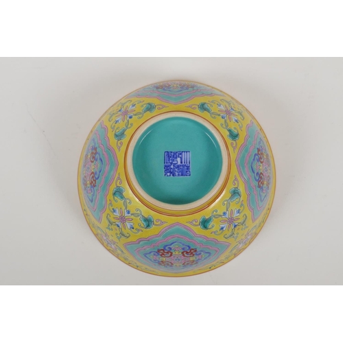 30 - An enamelled porcelain rice bowl with famille rose decoration on a yellow ground and a turquoise int... 