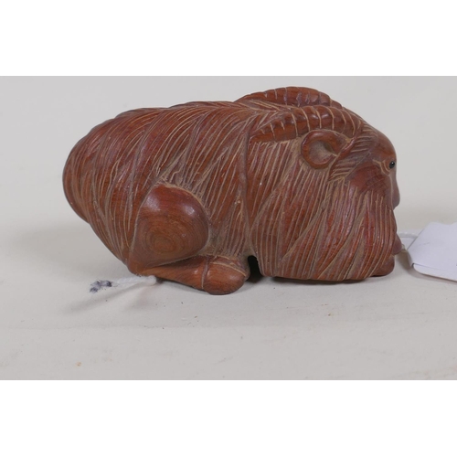 31 - A Japanese hardwood netsuke carved as a goat, 3