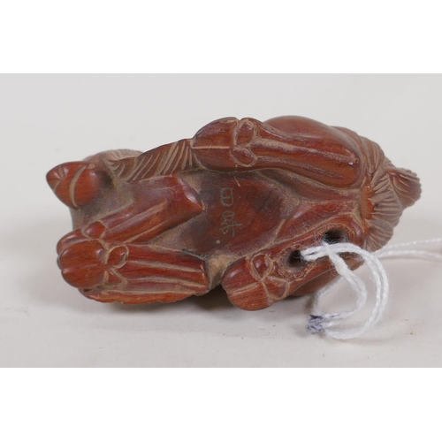 31 - A Japanese hardwood netsuke carved as a goat, 3