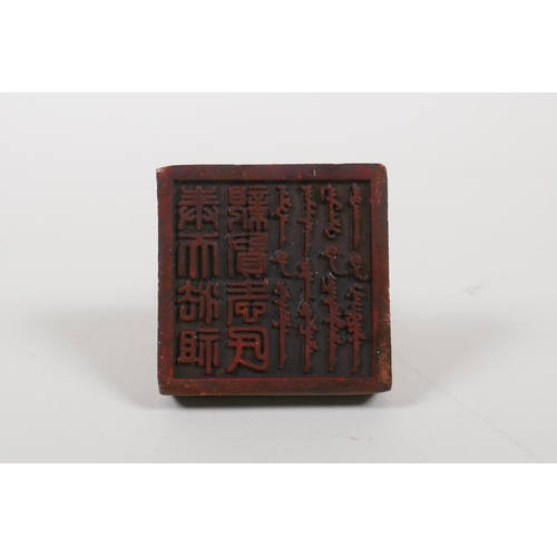 35 - A Chinese archaic style bronze seal with two entwined kylin as a knop, 2