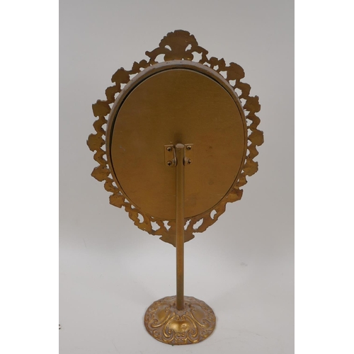 42 - A cast brass framed dressing table mirror on pedestal stand, 17½