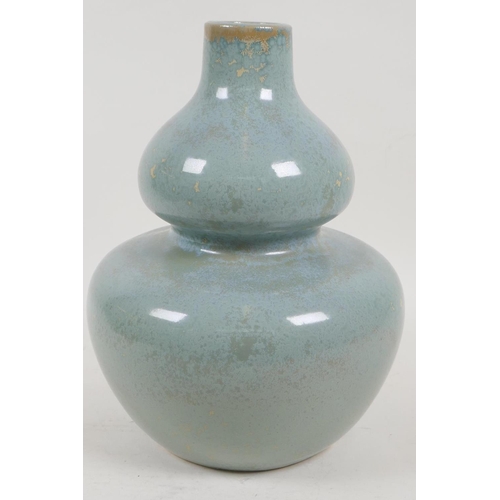 46 - A celadon glazed studio pottery double gourd vase, 10