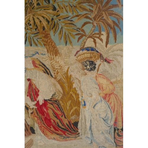 51 - A C19th needlework tapestry panel depicting Moses and the Pharoah's daughter at the river's edge, in... 