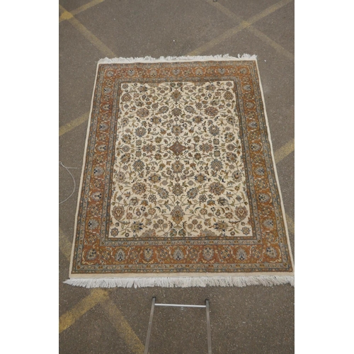 1178 - An antique cream ground deep pile wool tabriz carpet, 93