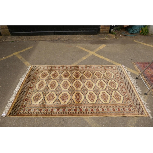 1188 - A gold ground wool Bokhara carpet, signed, 52