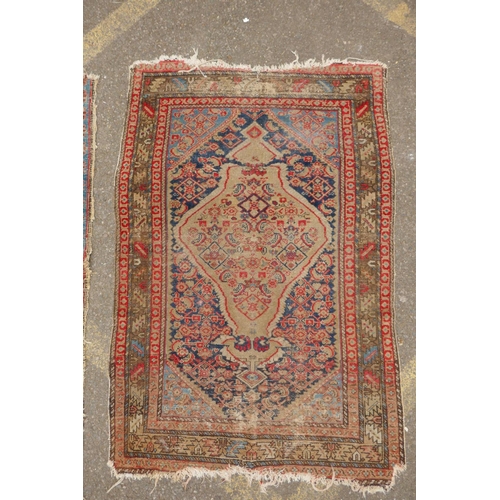 1182 - A Persian blue ground wool rug with geometric medallions and stylised birds design, a red ground Her... 