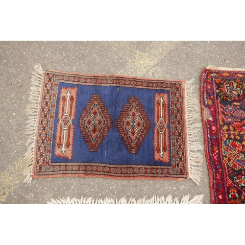 1175 - A Turkish rust ground wool rug with a medallion design, a worn red ground Bokhara runner, a deep pil... 