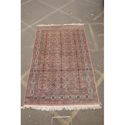 1193 - A Persian terracotta ground full pile wool carpet, decorated with an all over geometric design, 73