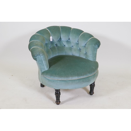 1195 - A small Victorian button back tub chair on turned supports